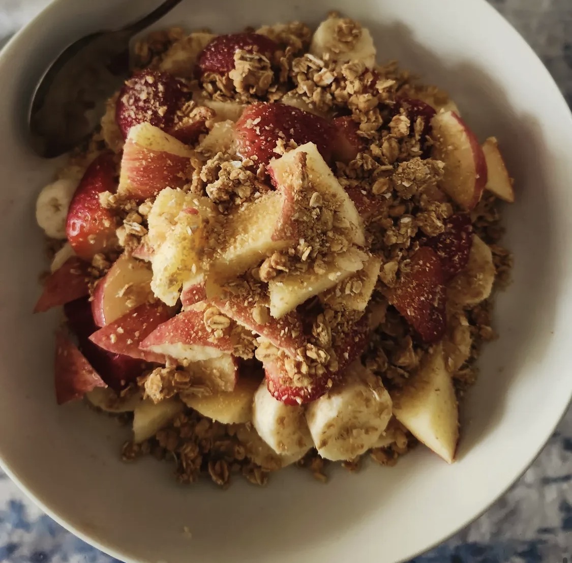 Bowl of apples, bananas and granola